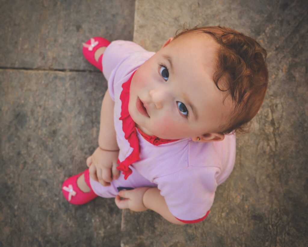 A baby boy in a white and red outfit