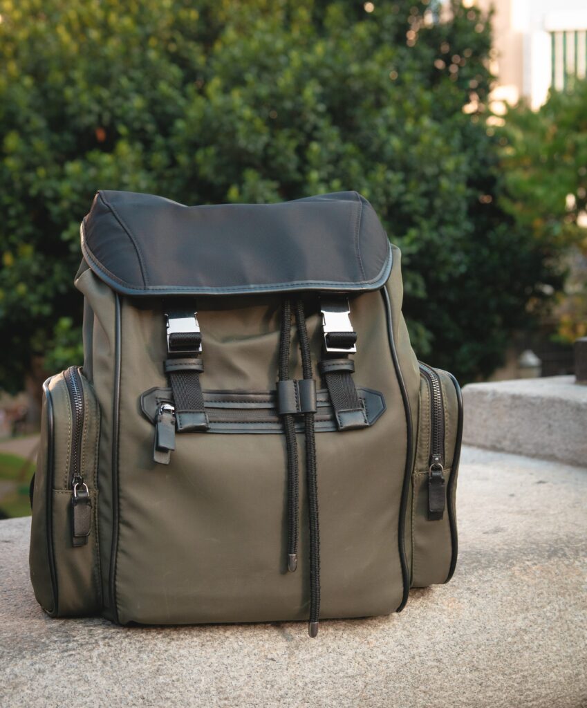 a backpack on the ground with trees in the background.