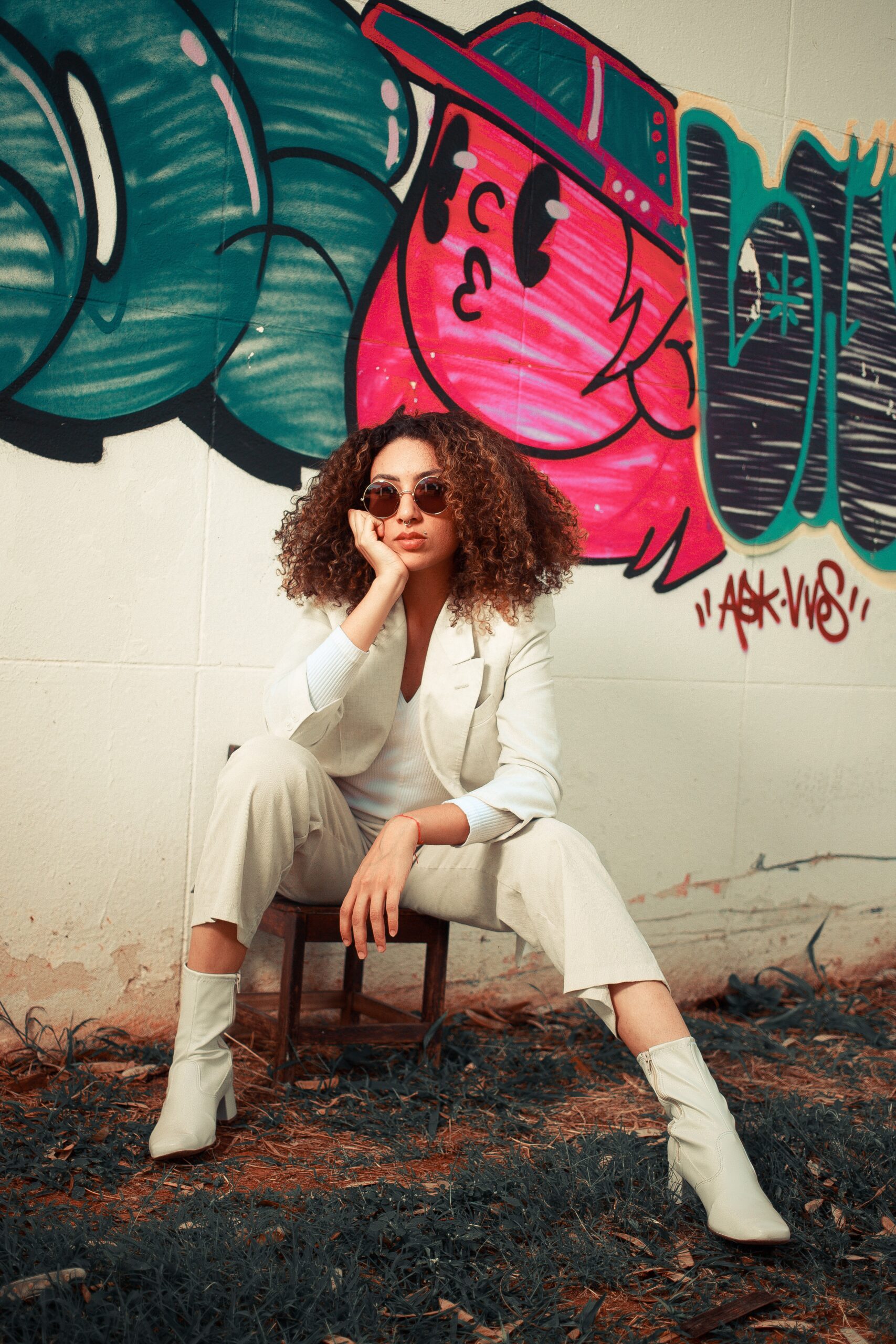 A female model adorning a high end white suit and fashionable white boots