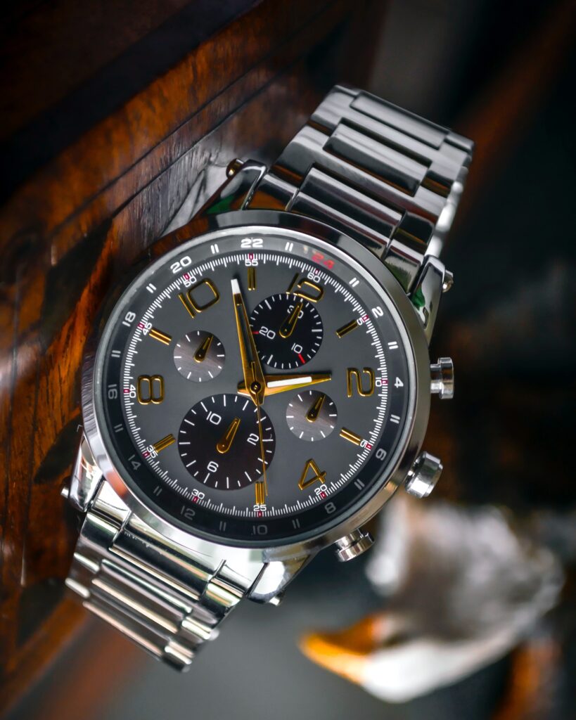 A silver watch on a brown surface