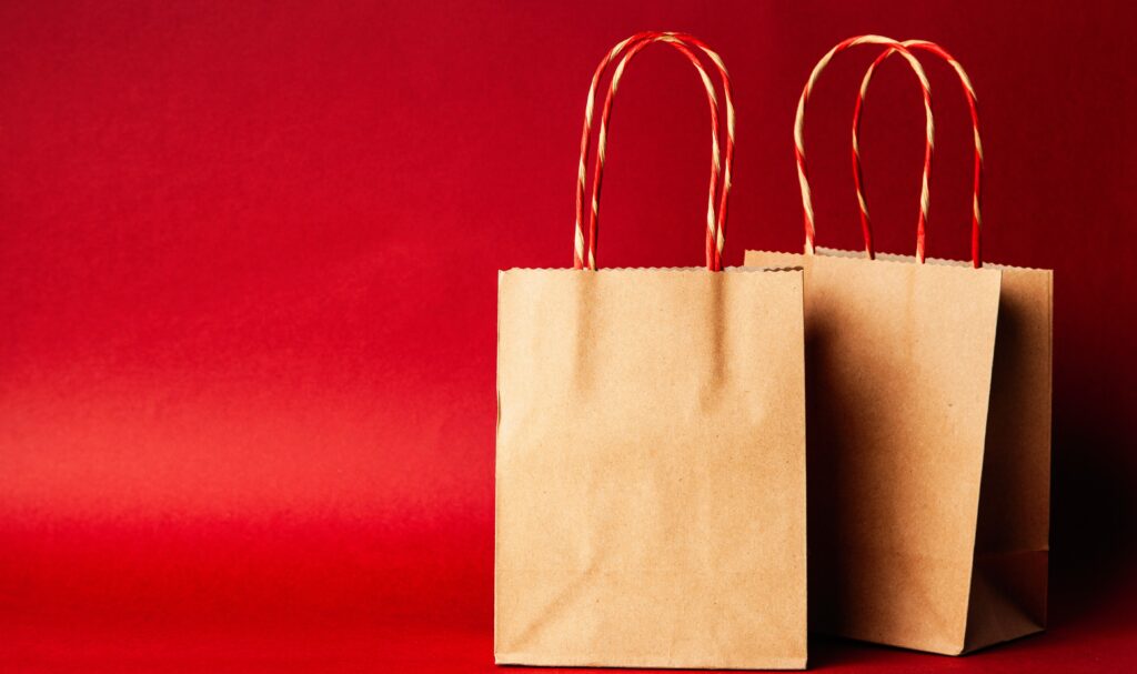 two brown paper bags on a red background.