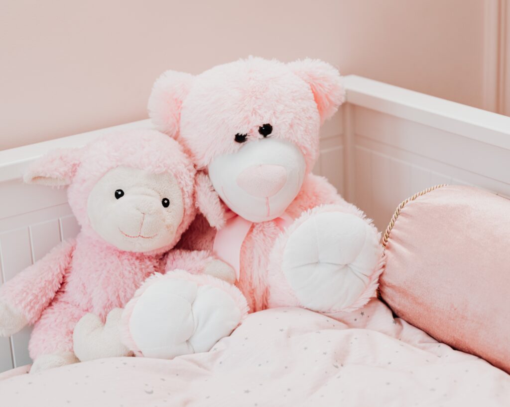 Pink dolls arranged in a comfy bed