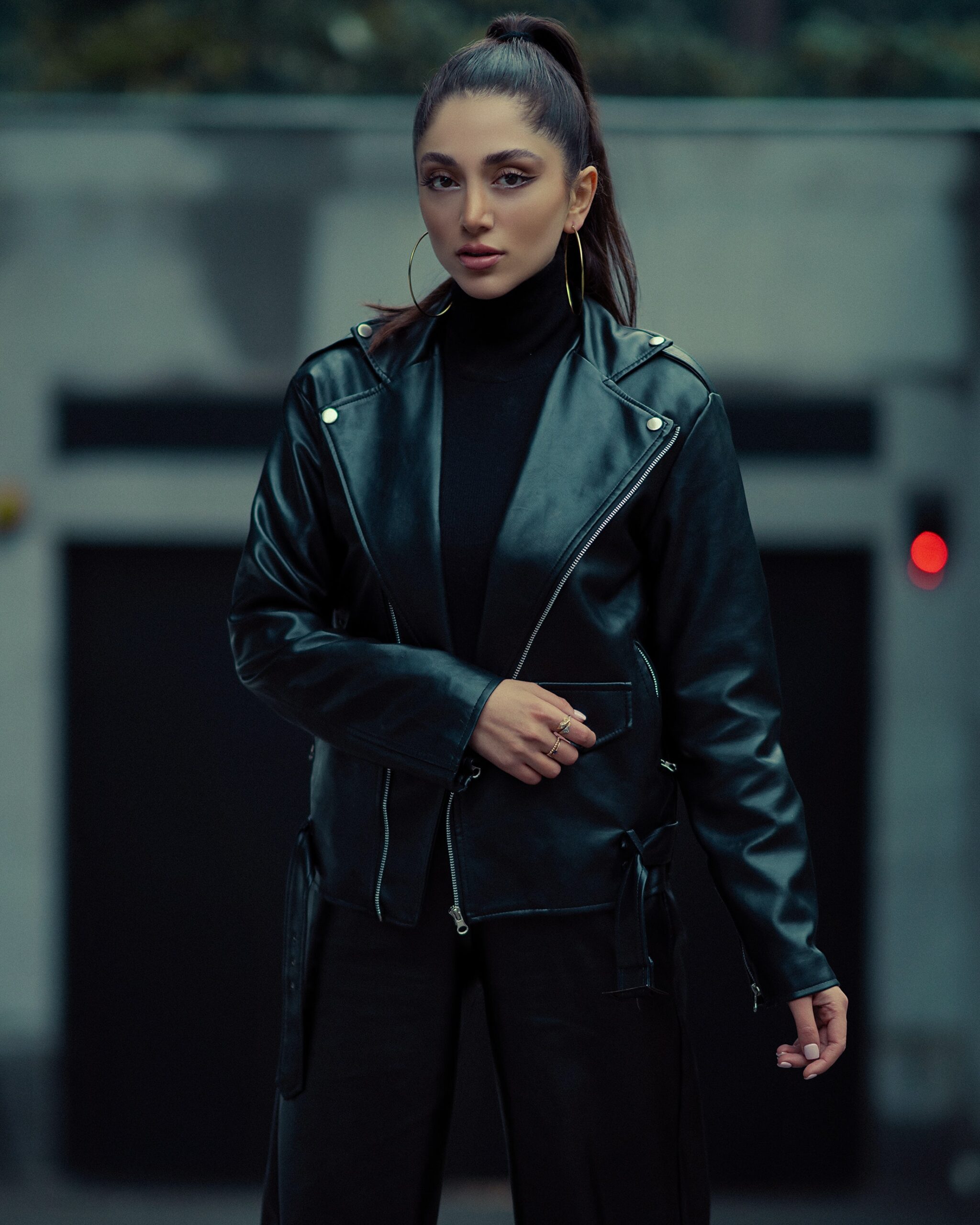 A woman in a cute black leather jacket and a black turtle neck