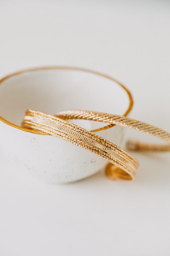 Gold plated jewelry consisting of bangles in a white enamel